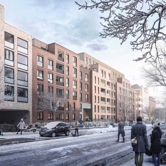 Modernes Wohngebäude im Winter mit schneebedeckten Bäumen und Menschen auf der Straße.